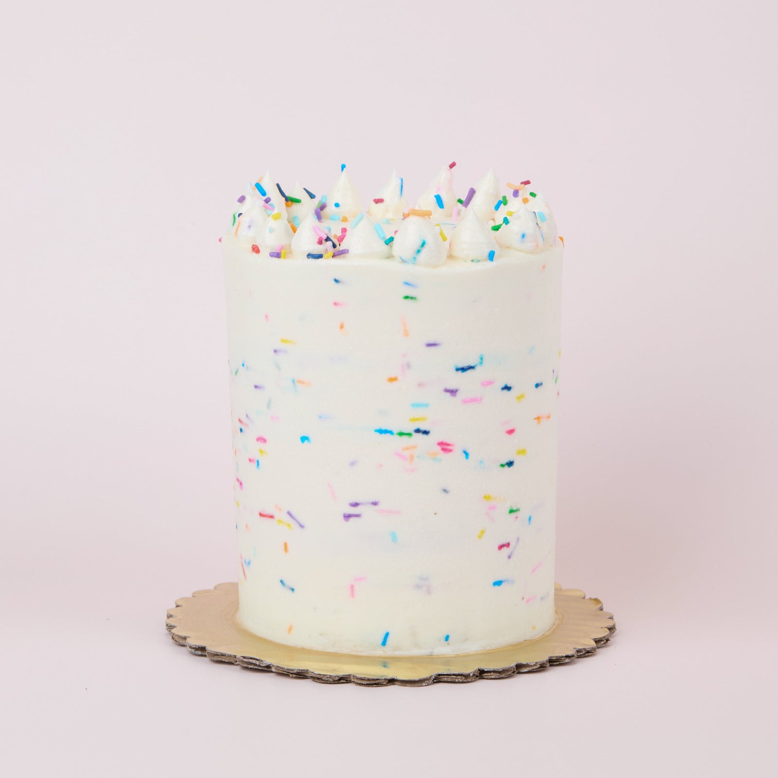 Party cake with rainbow sprinkles mixed into vanilla buttercream
