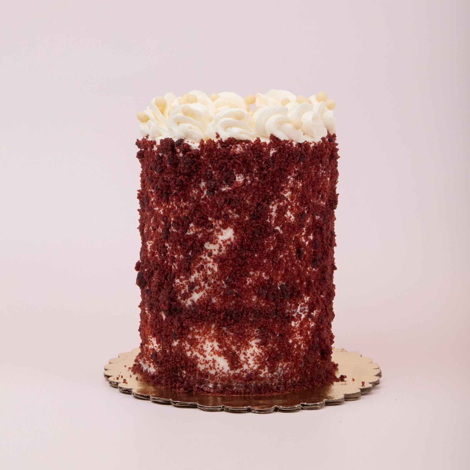 Red velvet cake coated in red velvet cake crumbs