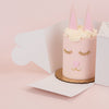 small pink cake disguised as a bunny packaged up in our to-go box